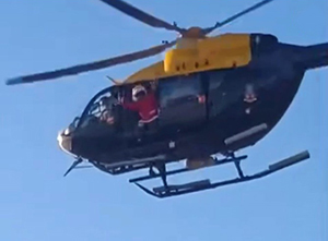 santa claus waving from a helicopter